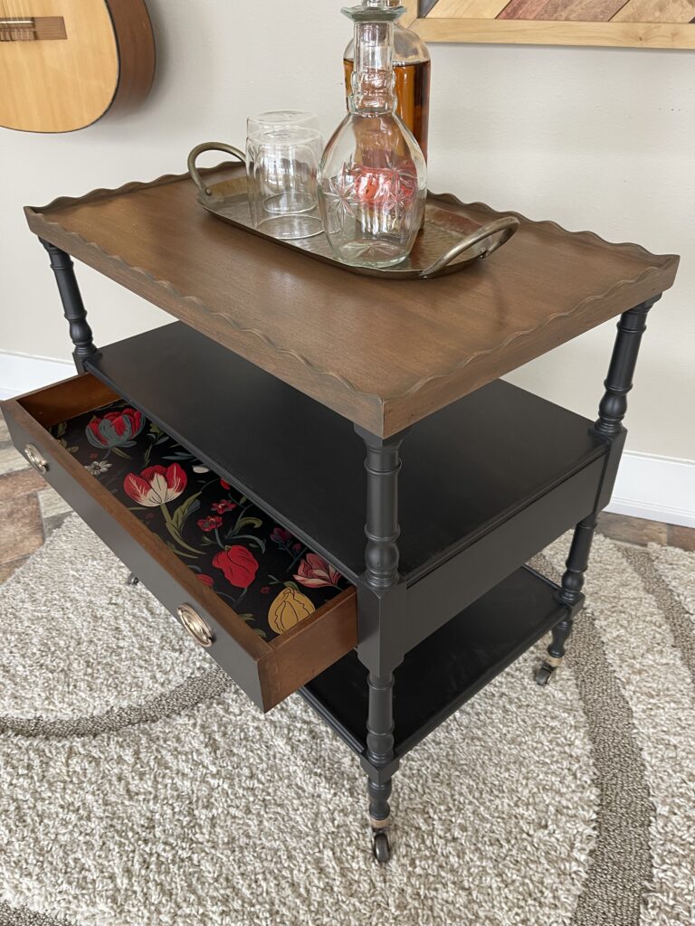serving cart with floral paper lined drawer and bar items on top